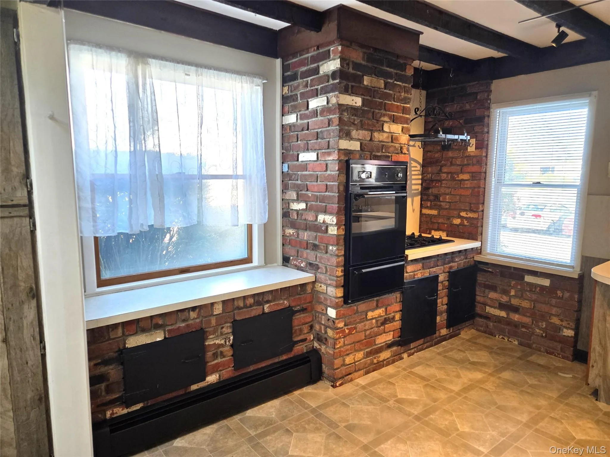 Large Eat In Kitchen With Original Beamed Ceilings, Walls Of Storage Cabinetry, A Separate Double Door Pantry, Ample Counter/Serving Space & Built In Barstool Area, Charming Brick Walls With A Built In Wall Oven & Separate Cooktop, Ample Room For A Good Sized Table & Chairs, And A Separate Mud Room With A Newer Full Sized Washer & Dryer, And Additional Storage/Cabinetry. Large Eat In Kitchen With Original Beamed Ceilings, Walls Of Storage Cabinetry, A Separate Double Door Pantry, Ample Counter/Serving Space & Built In Barstool Area, Charming Brick Walls With A Built In Wall Oven & Separate Cooktop, Ample Room For A Good Sized Table & Chairs, And A Separate Mud Room With A Newer Full Sized Washer & Dryer, And Additional Storage/Cabinetry.