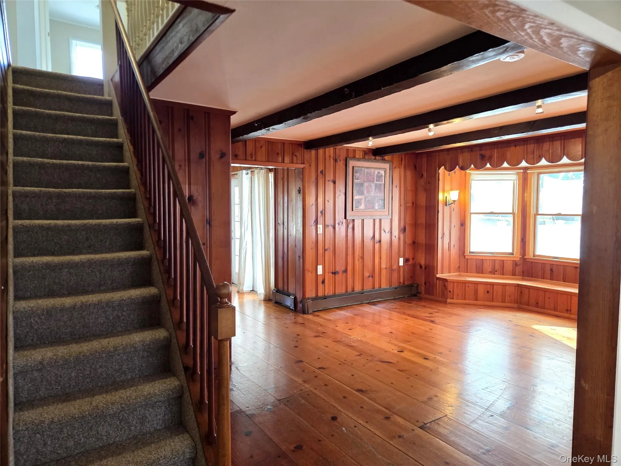 The Living Room Offers Original Beamed Ceilings, Wide Plank Hardwood Floors, Tongue & Groove Pine Walls, Ample Room For Furniture & A Charming Vintage Stairway To The Second Level. The Living Room Offers Original Beamed Ceilings, Wide Plank Hardwood Floors, Tongue & Groove Pine Walls, Ample Room For Furniture & A Charming Vintage Stairway To The Second Level.