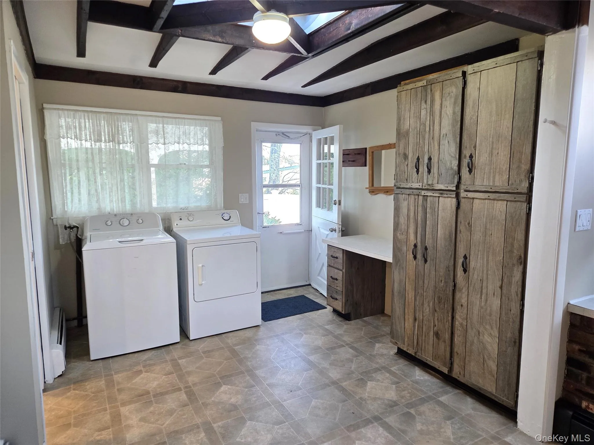 Large Eat In Kitchen With Original Beamed Ceilings, Walls Of Storage Cabinetry, A Separate Double Door Pantry, Ample Counter/Serving Space & Built In Barstool Area, Charming Brick Walls With A Built In Wall Oven & Separate Cooktop, Ample Room For A Good Sized Table & Chairs, And A Separate Mud Room With A Newer Full Sized Washer & Dryer, Additional Storage/Cabinetry And A Built In Desk. Large Eat In Kitchen With Original Beamed Ceilings, Walls Of Storage Cabinetry, A Separate Double Door Pantry, Ample Counter/Serving Space & Built In Barstool Area, Charming Brick Walls With A Built In Wall Oven & Separate Cooktop, Ample Room For A Good Sized Table & Chairs, And A Separate Mud Room With A Newer Full Sized Washer & Dryer, Additional Storage/Cabinetry And A Built In Desk.