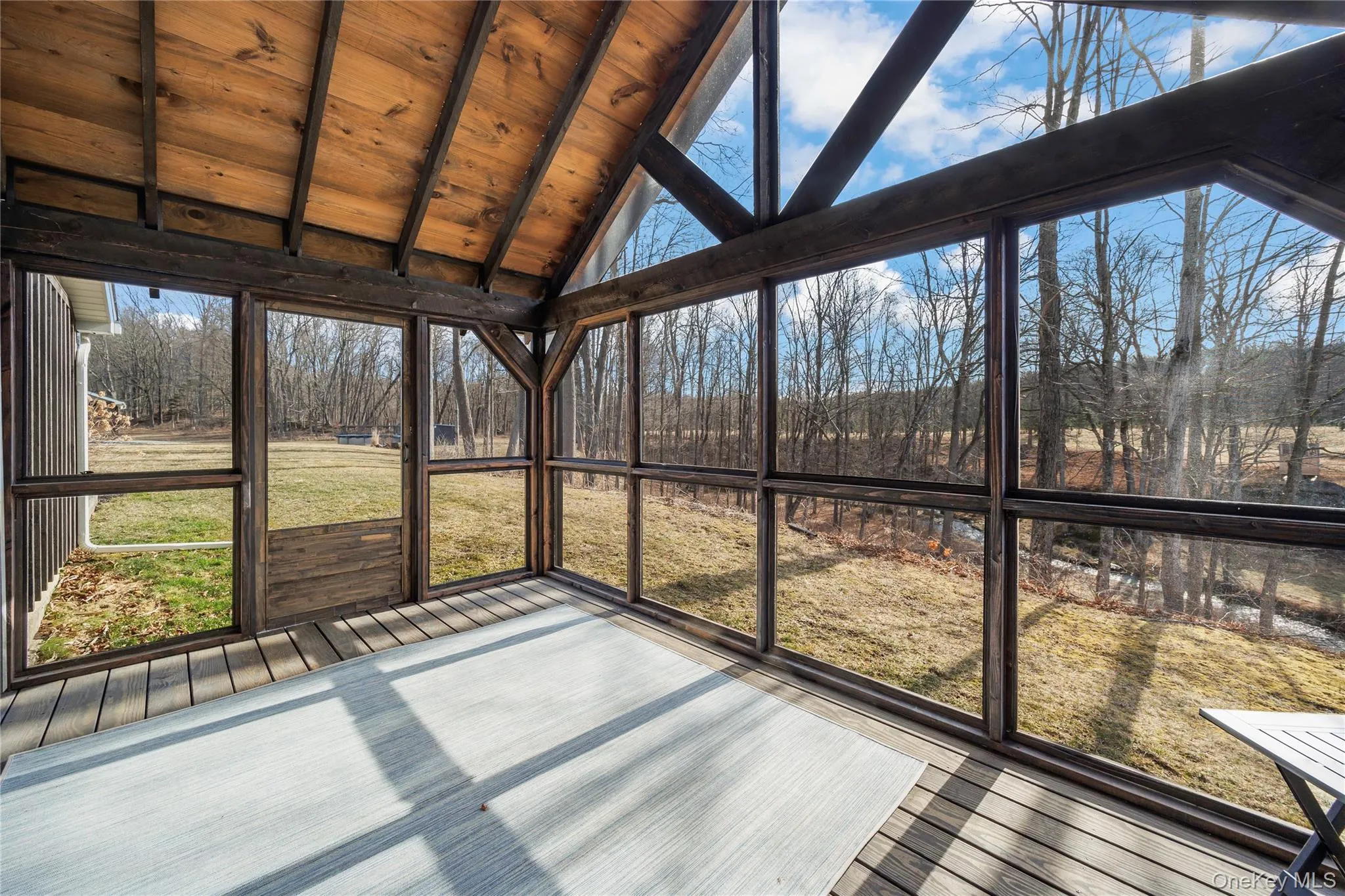 Lovely screened-in porch with beamed ceiling overlooking Landsman Kill Lovely screened-in porch with beamed ceiling overlooking Landsman Kill