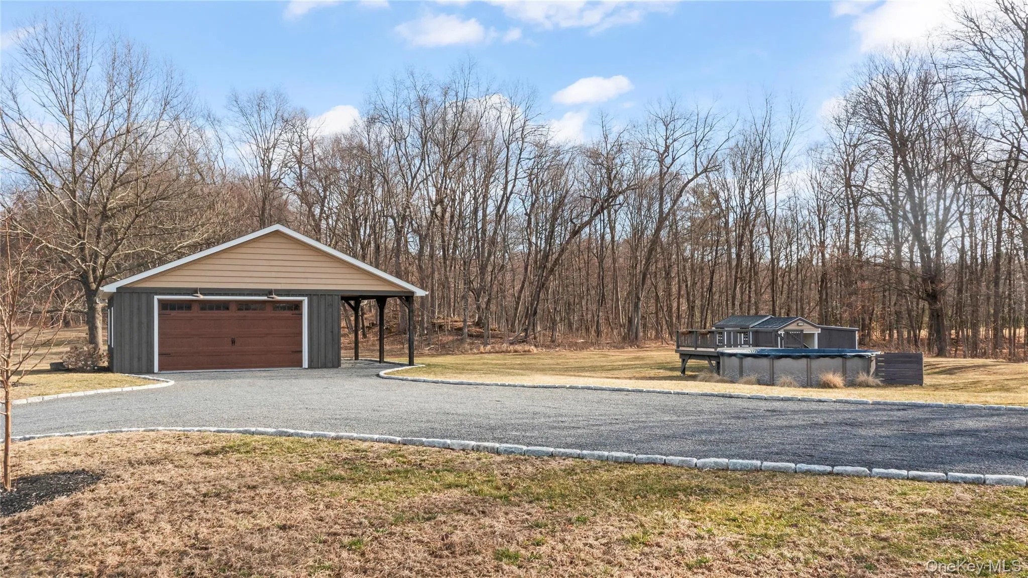 Detached garage with above-ground pool in the distance Detached garage with above-ground pool in the distance