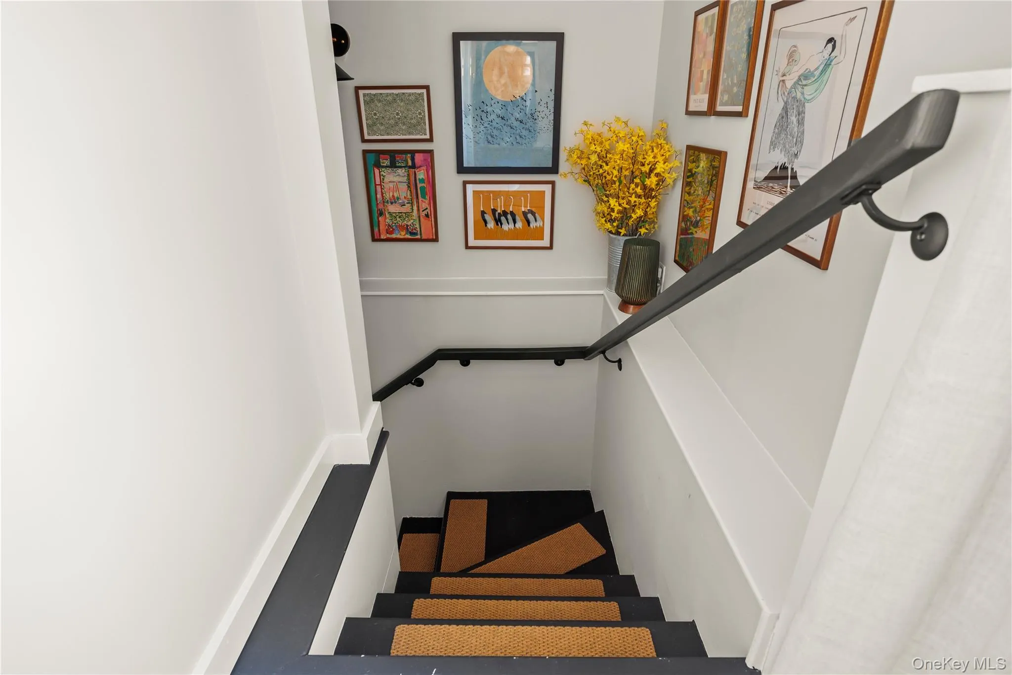Staircase featuring baseboards Staircase featuring baseboards