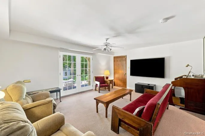 White walls, light-toned carpeting, and a built-in ceiling fan with integrated lighting White walls, light-toned carpeting, and a built-in ceiling fan with integrated lighting