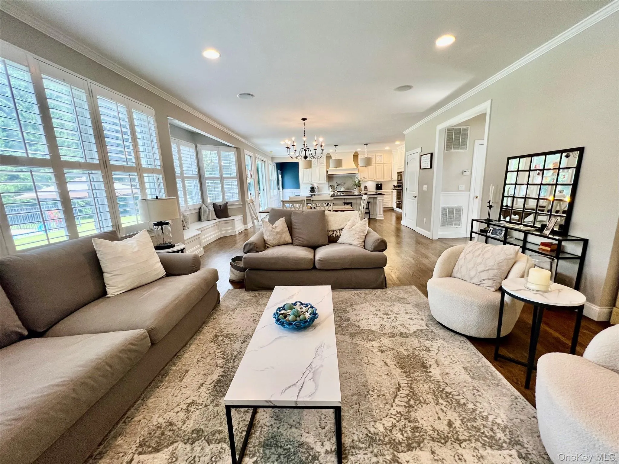 Great Room with FP opent to Kitchen w White Cabinetry and White Quartz Island Great Room with FP opent to Kitchen w White Cabinetry and White Quartz Island