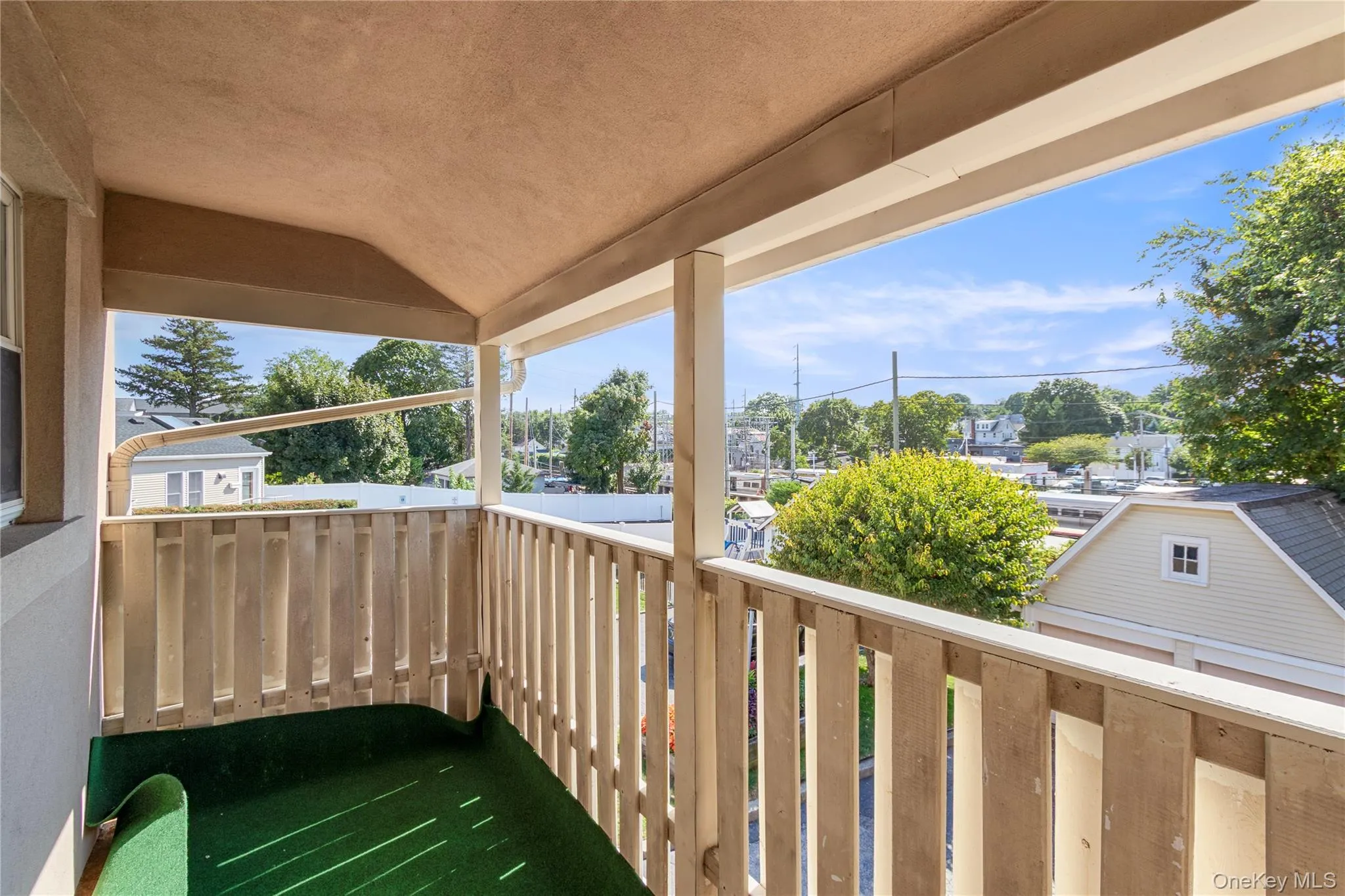 Covered outdoor balcony with wood railings and stucco ceiling Covered outdoor balcony with wood railings and stucco ceiling