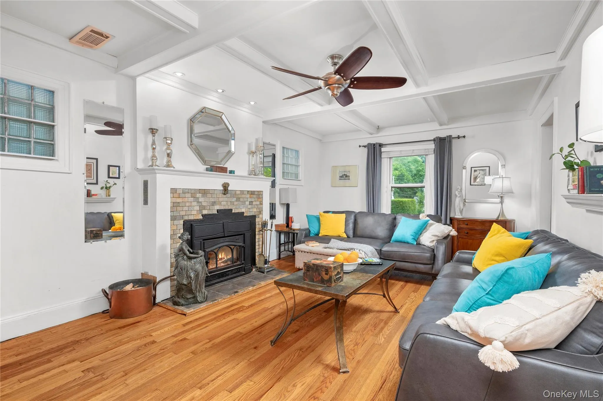 Living room featuring a charming wood-burning stove that enhances the warmth and character of the home Living room featuring a charming wood-burning stove that enhances the warmth and character of the home