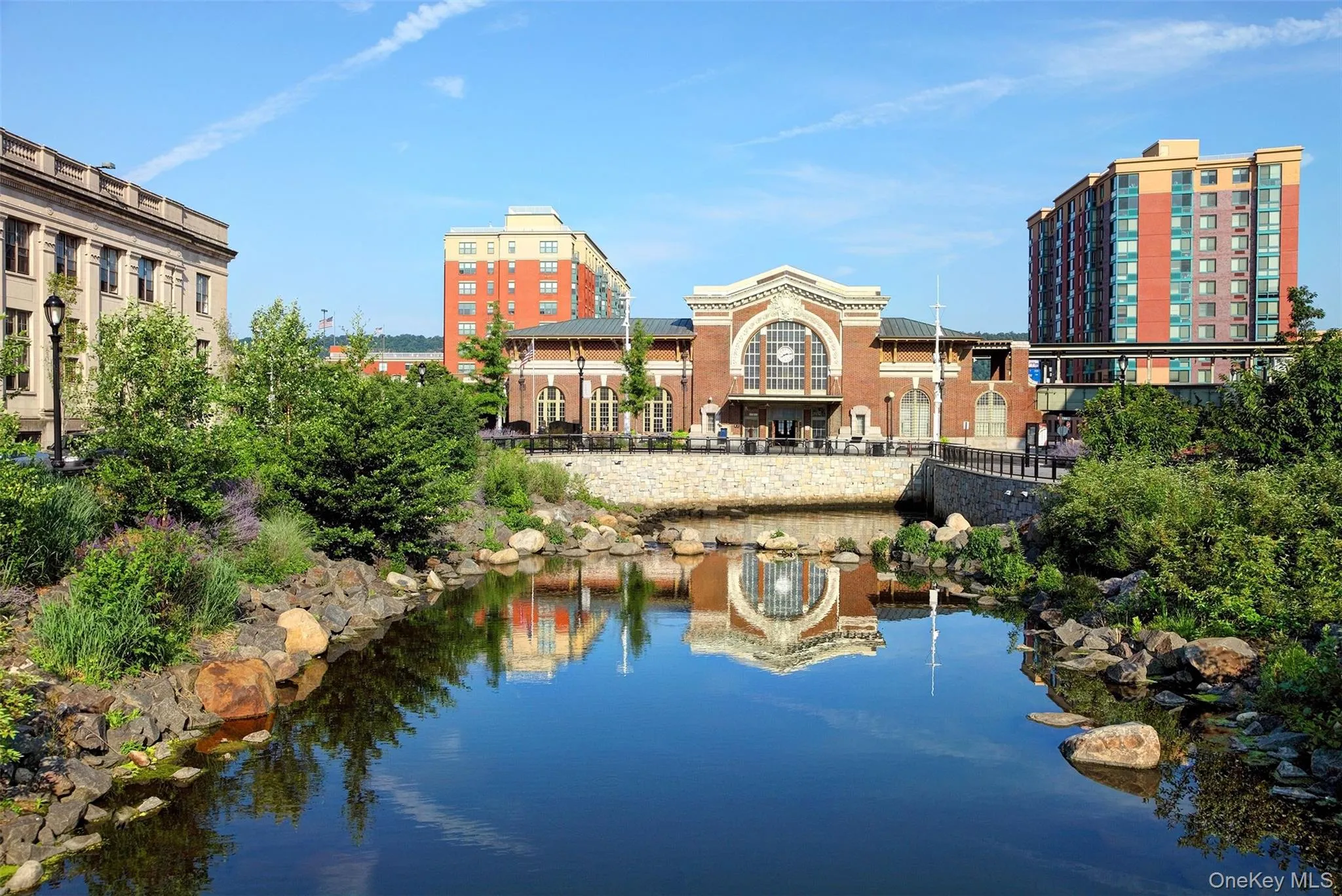 Yonkers Metro North train station is an express stop. Daylighted Saw MIll River in foreground. Yonkers Metro North train station is an express stop. Daylighted Saw MIll River in foreground.