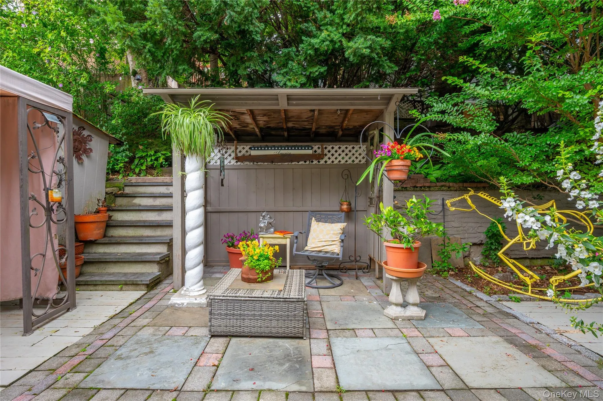 Paved patio with a covered seating area Paved patio with a covered seating area