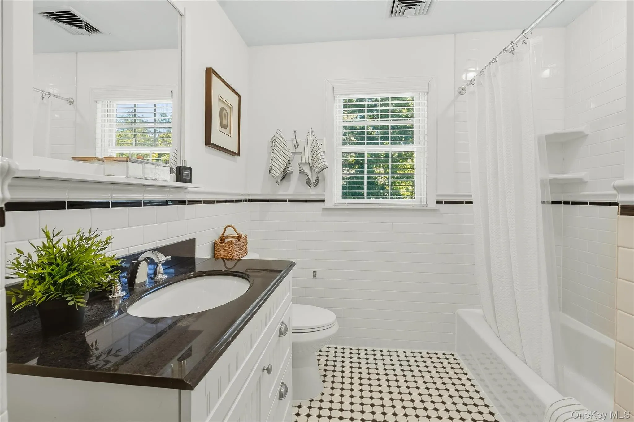 A beautifully appointed hall bath, convenient to the bedrooms. A beautifully appointed hall bath, convenient to the bedrooms.
