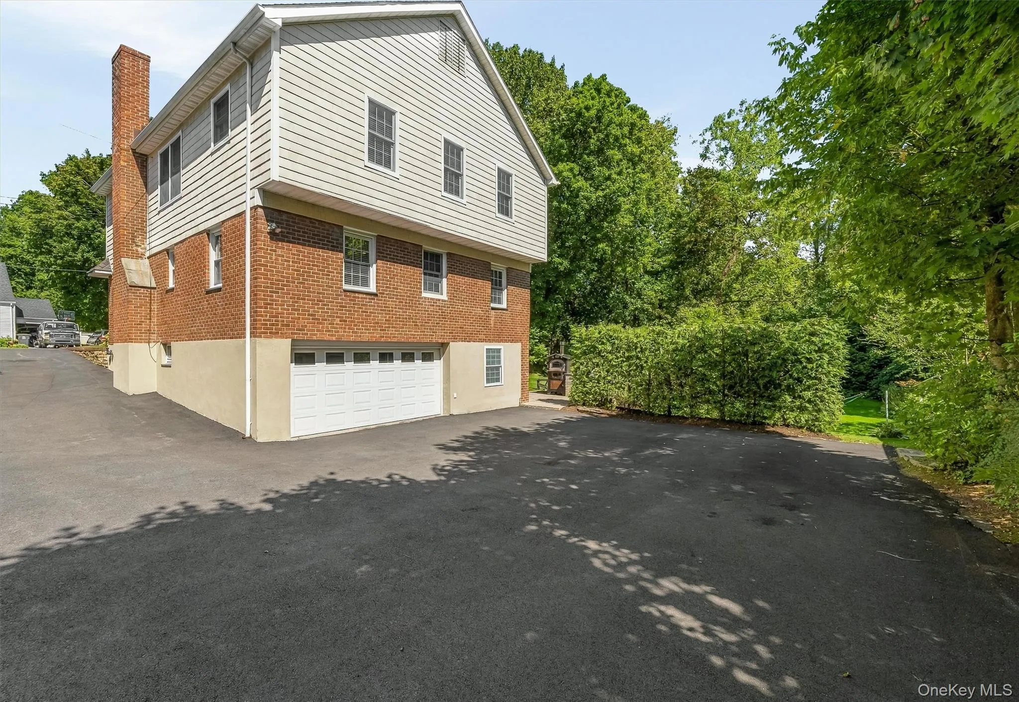 A spacious driveway with room for six cars, plus a garage. A spacious driveway with room for six cars, plus a garage.