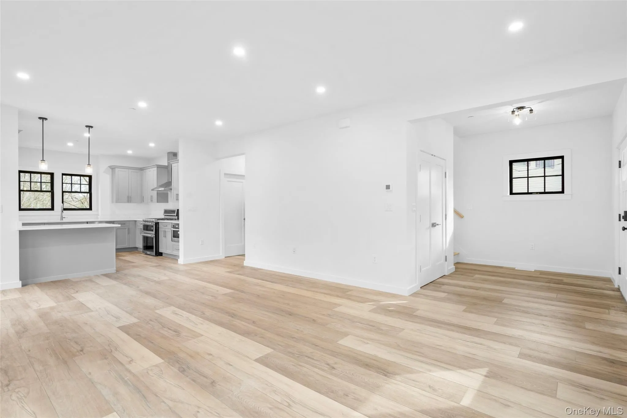 Unfurnished living room with light hardwood / wood-style flooring Unfurnished living room with light hardwood / wood-style flooring