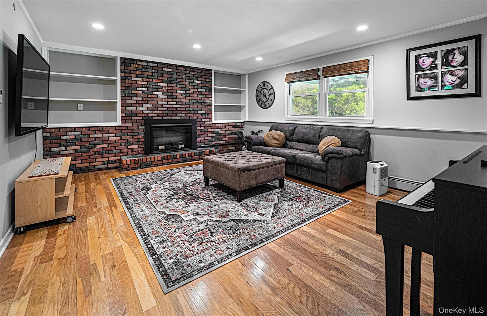 Lower level recreation room with fireplace and window view to backyard. Lower level recreation room with fireplace and window view to backyard.