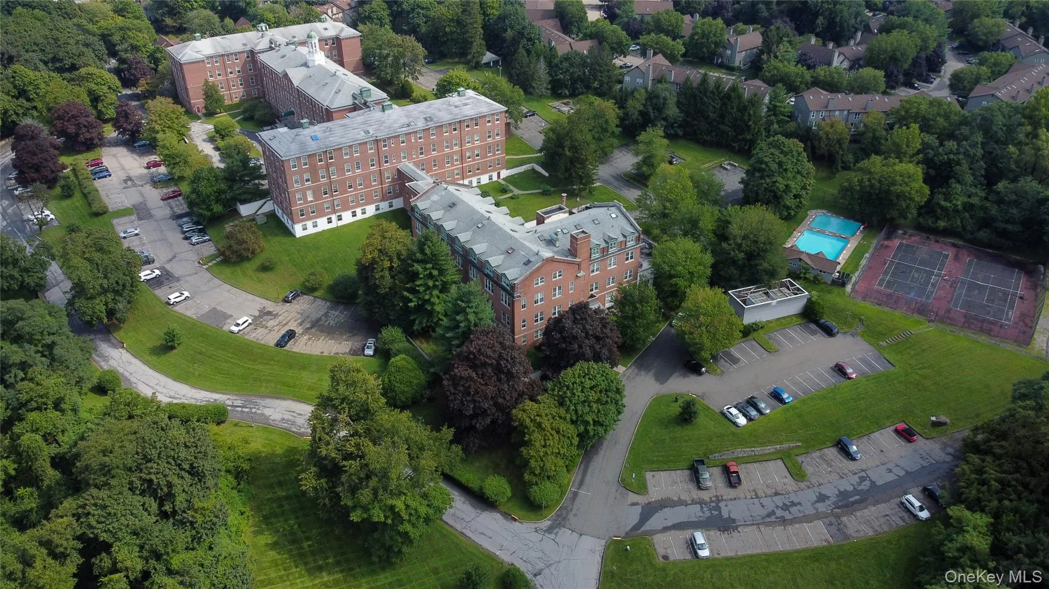 Aerial view of the property highlighting its spacious grounds and residential setting. Aerial view of the property highlighting its spacious grounds and residential setting.