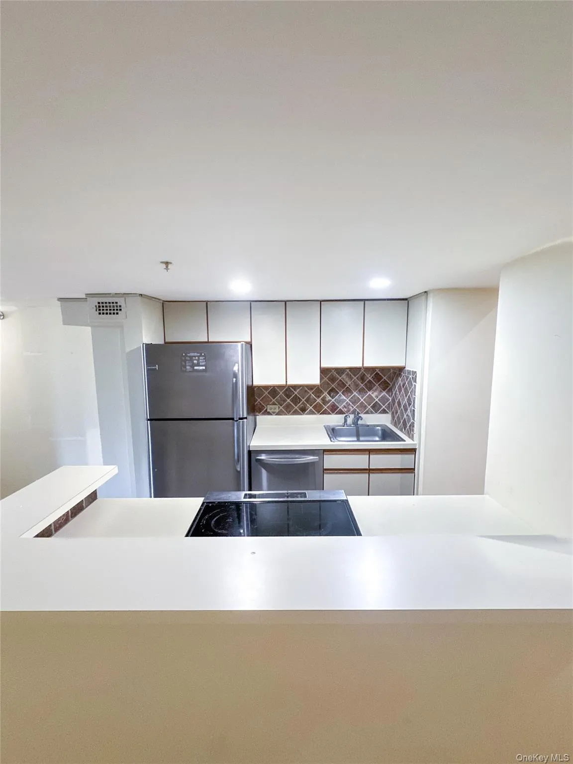 Open kitchen with breakfast bar overlooking the spacious living and dining area. Open kitchen with breakfast bar overlooking the spacious living and dining area.