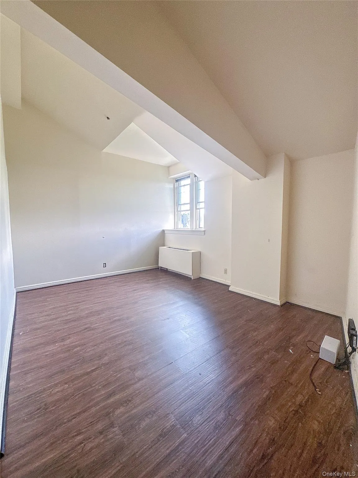 Spacious living room featuring wood flooring, soaring ceilings, and abundant natural light. Spacious living room featuring wood flooring, soaring ceilings, and abundant natural light.