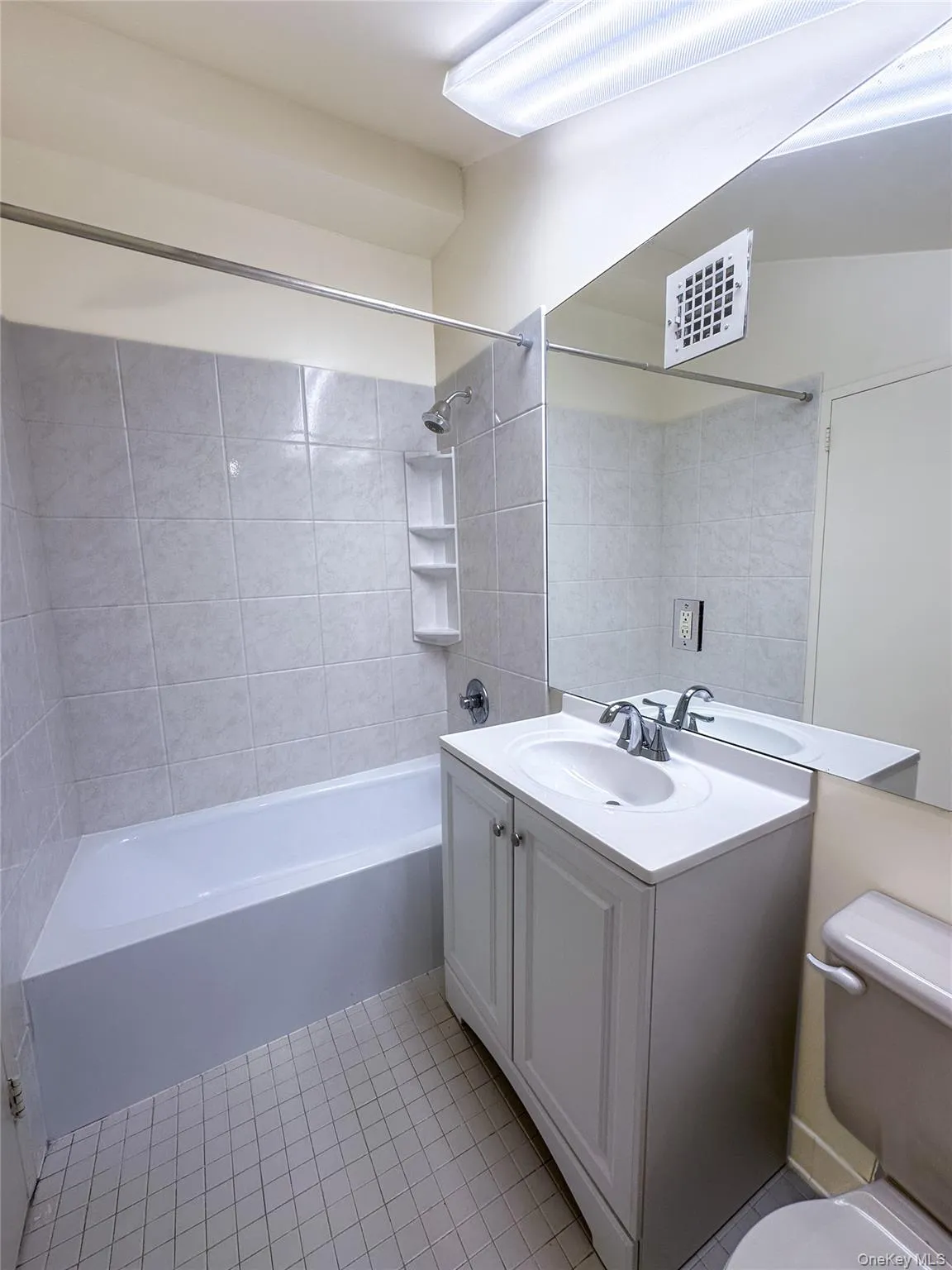 Private loft-level full bathroom featuring an updated vanity, oversized mirror, and tub/shower combination. Private loft-level full bathroom featuring an updated vanity, oversized mirror, and tub/shower combination.