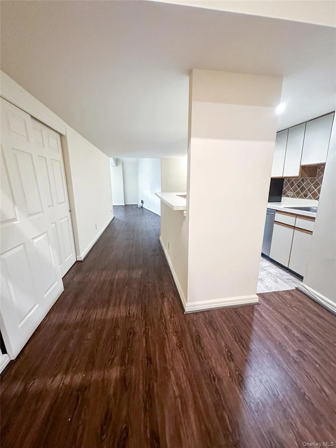 Spacious open-concept living and dining area featuring wood flooring and abundant natural light. Spacious open-concept living and dining area featuring wood flooring and abundant natural light.