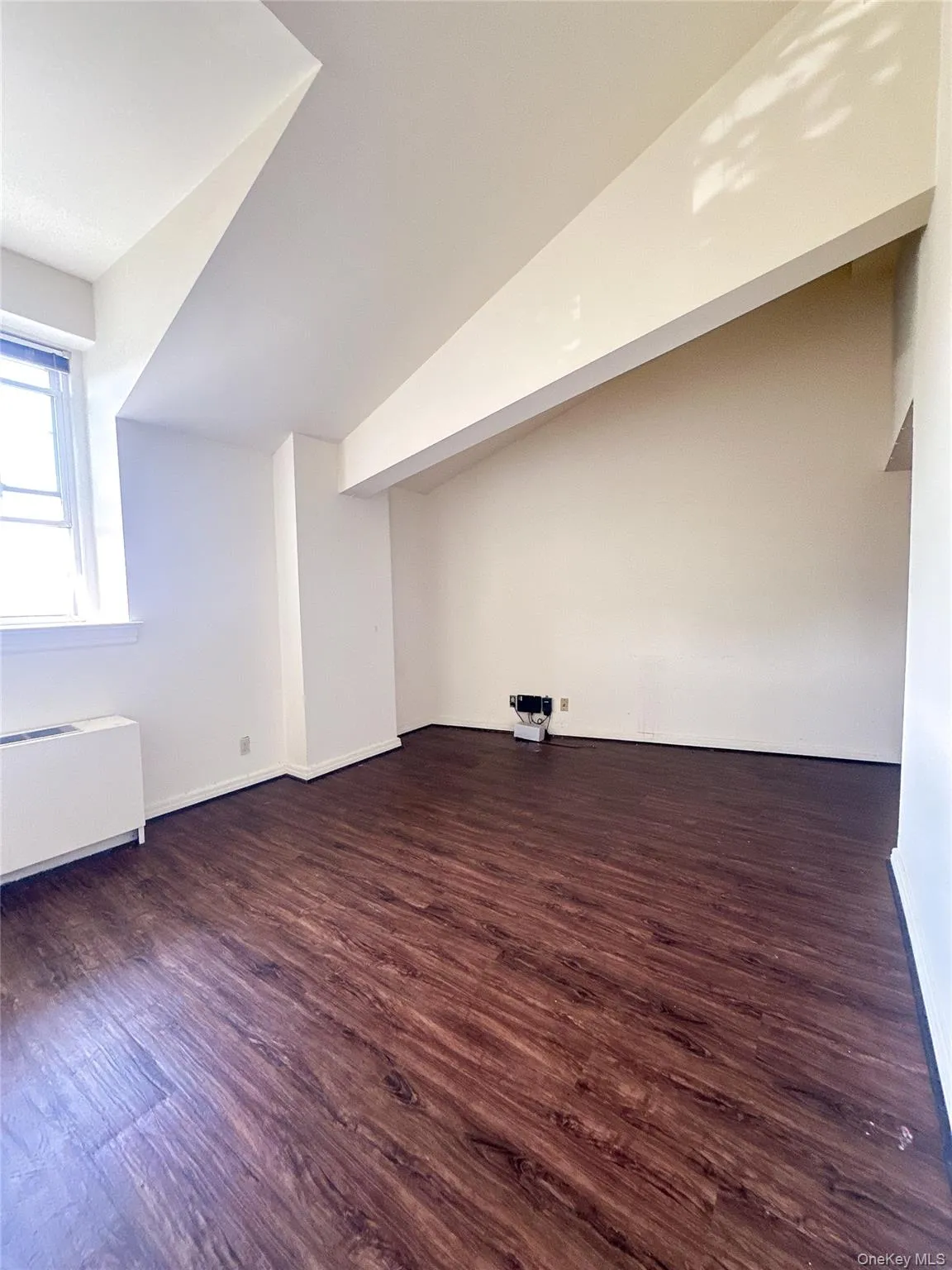 Sun-filled living space highlighted by tall ceilings, wood flooring, and an open view throughout the main level. Sun-filled living space highlighted by tall ceilings, wood flooring, and an open view throughout the main level.
