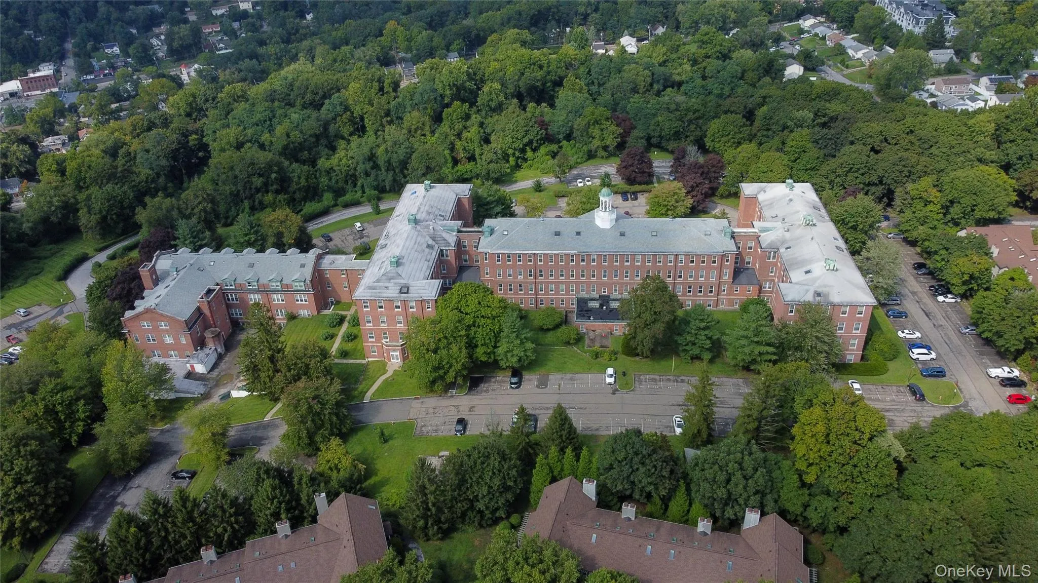 Aerial view of the property highlighting its spacious grounds and residential setting. Aerial view of the property highlighting its spacious grounds and residential setting.