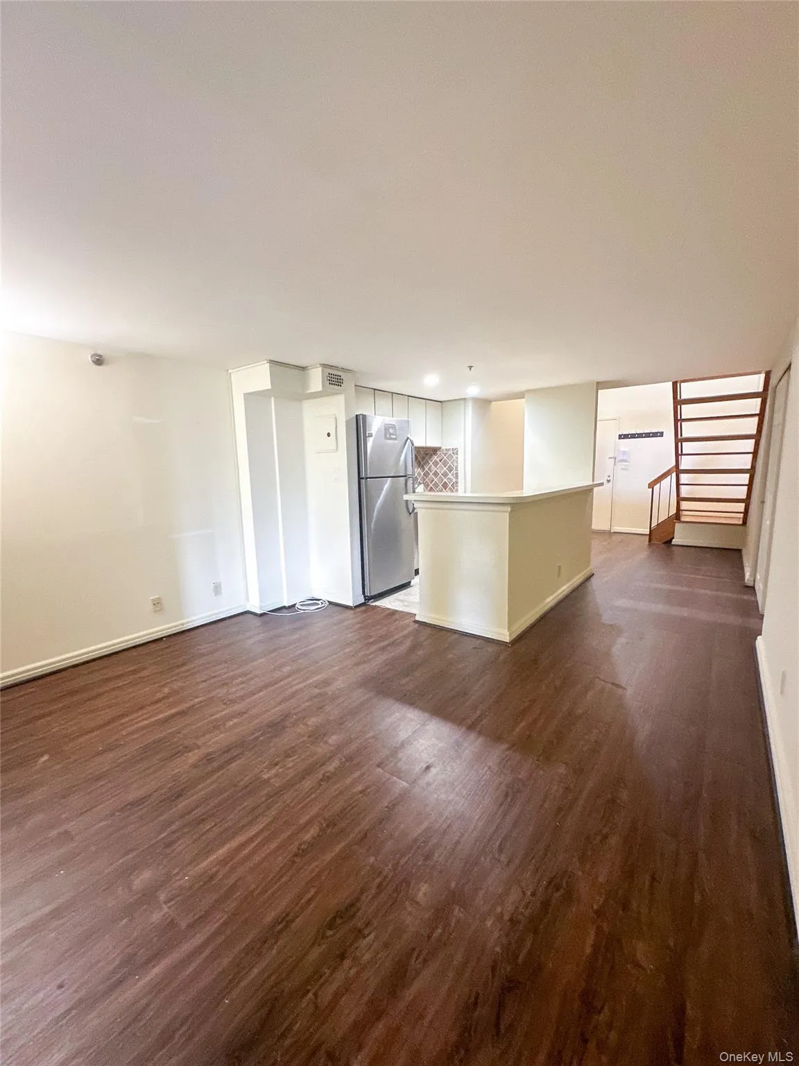 Open dining area flows seamlessly into the kitchen, featuring wood flooring and a convenient breakfast bar. Open dining area flows seamlessly into the kitchen, featuring wood flooring and a convenient breakfast bar.