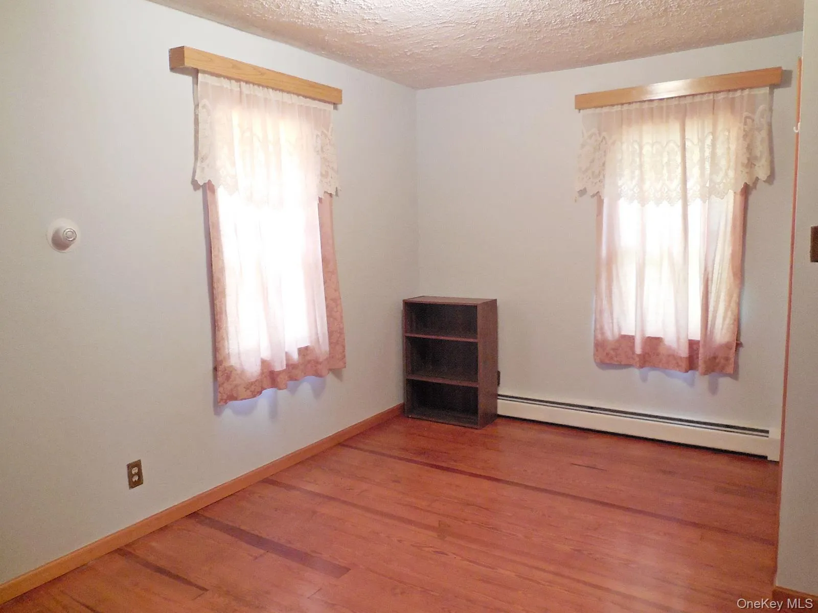 Bedroom 1. Hardwood flooring and light-toned walls Bedroom 1. Hardwood flooring and light-toned walls