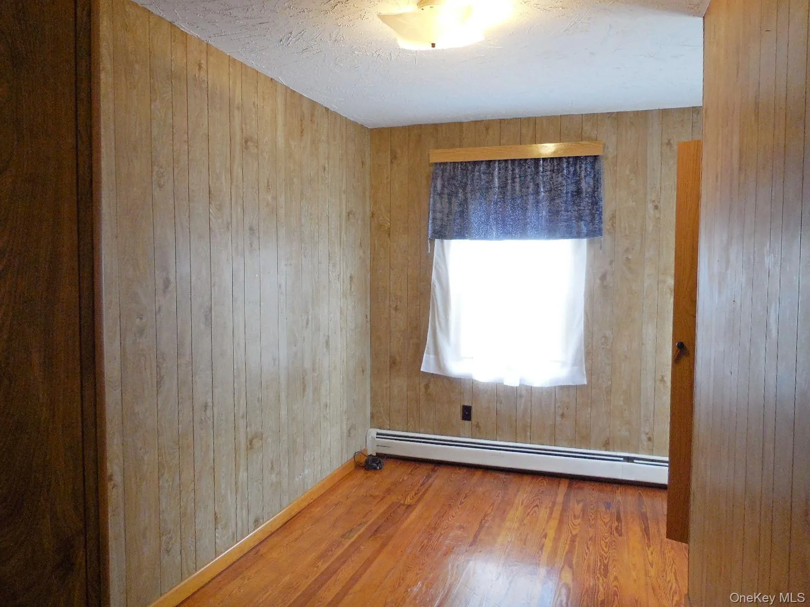 Bedrm 3. Wood floor, wood finish wall paneling, closet, second closet with built in shelving. Bedrm 3. Wood floor, wood finish wall paneling, closet, second closet with built in shelving.