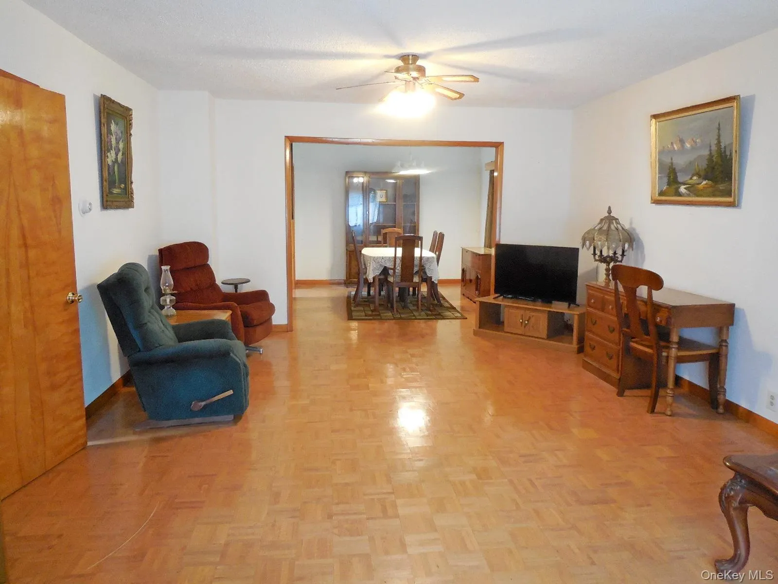 Parquet wood-finish flooring, white painted walls, and a ceiling fan with integrated lighting Parquet wood-finish flooring, white painted walls, and a ceiling fan with integrated lighting