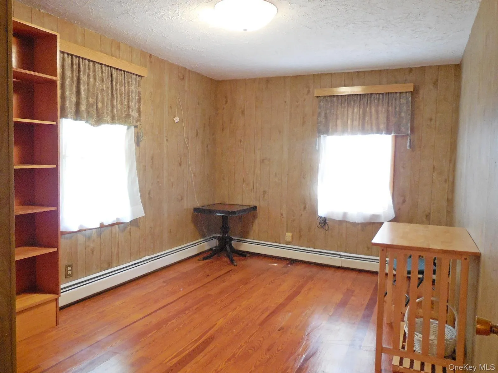 Bedrm 2. hardwood floor, double windows, closet, wood finish wall paneling. Bedrm 2. hardwood floor, double windows, closet, wood finish wall paneling.