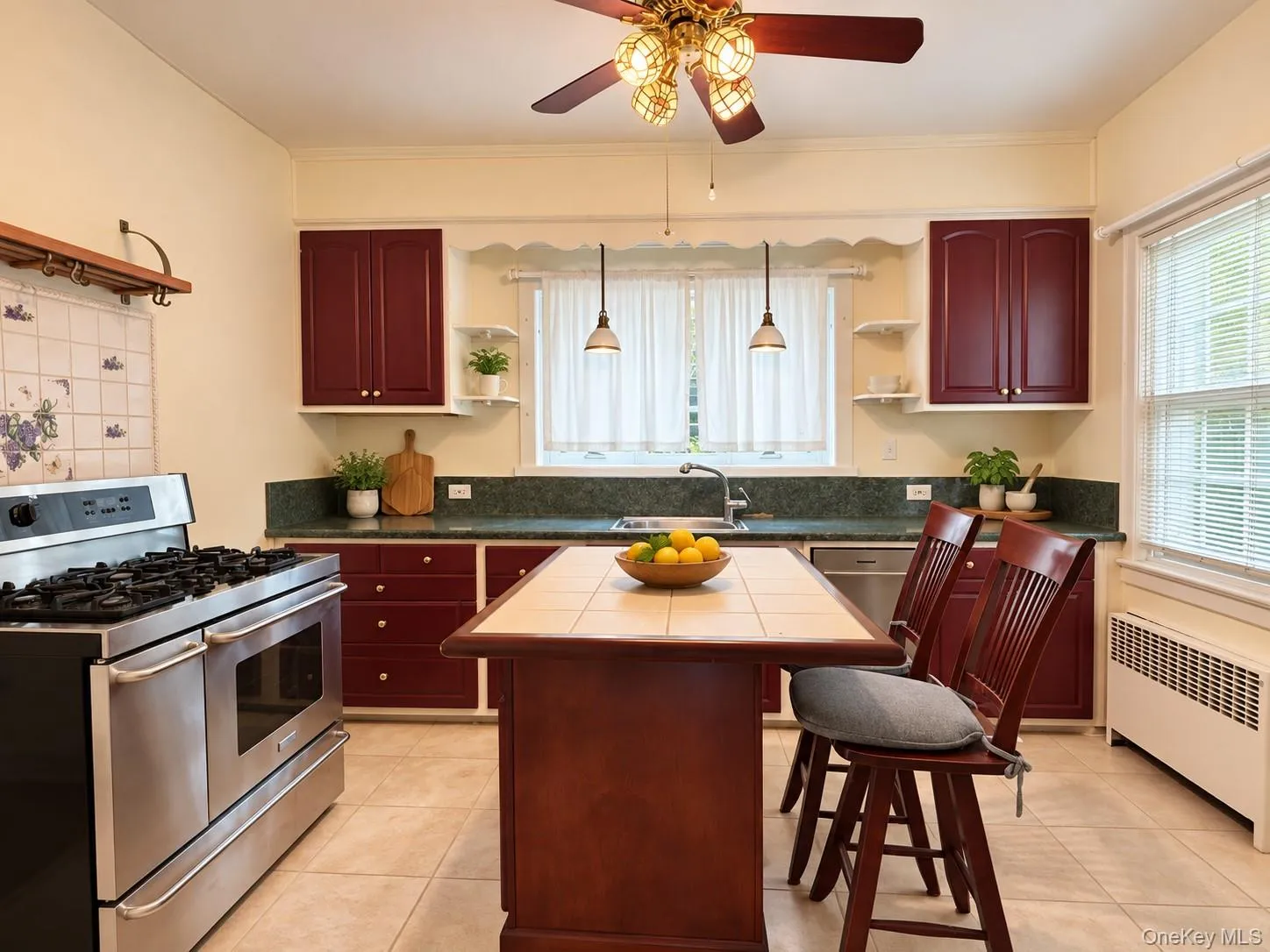 Kitchen featuring solid-color cabinetry, stone-finish countertops, professional-grade stainless steel range, ceramic-tiled kitchen island, and ceramic tile flooring Kitchen featuring solid-color cabinetry, stone-finish countertops, professional-grade stainless steel range, ceramic-tiled kitchen island, and ceramic tile flooring