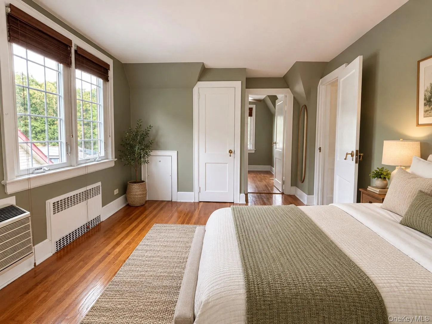 Hardwood flooring, multi-pane windows with integrated blinds, and solid-core interior doors with brass hardware Hardwood flooring, multi-pane windows with integrated blinds, and solid-core interior doors with brass hardware