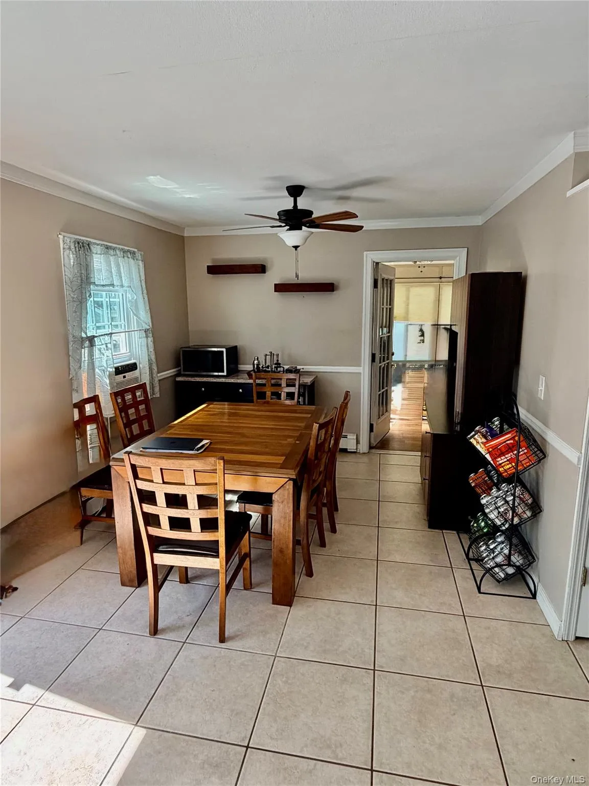 Tile flooring, ceiling fan, crown molding, double French doors Tile flooring, ceiling fan, crown molding, double French doors