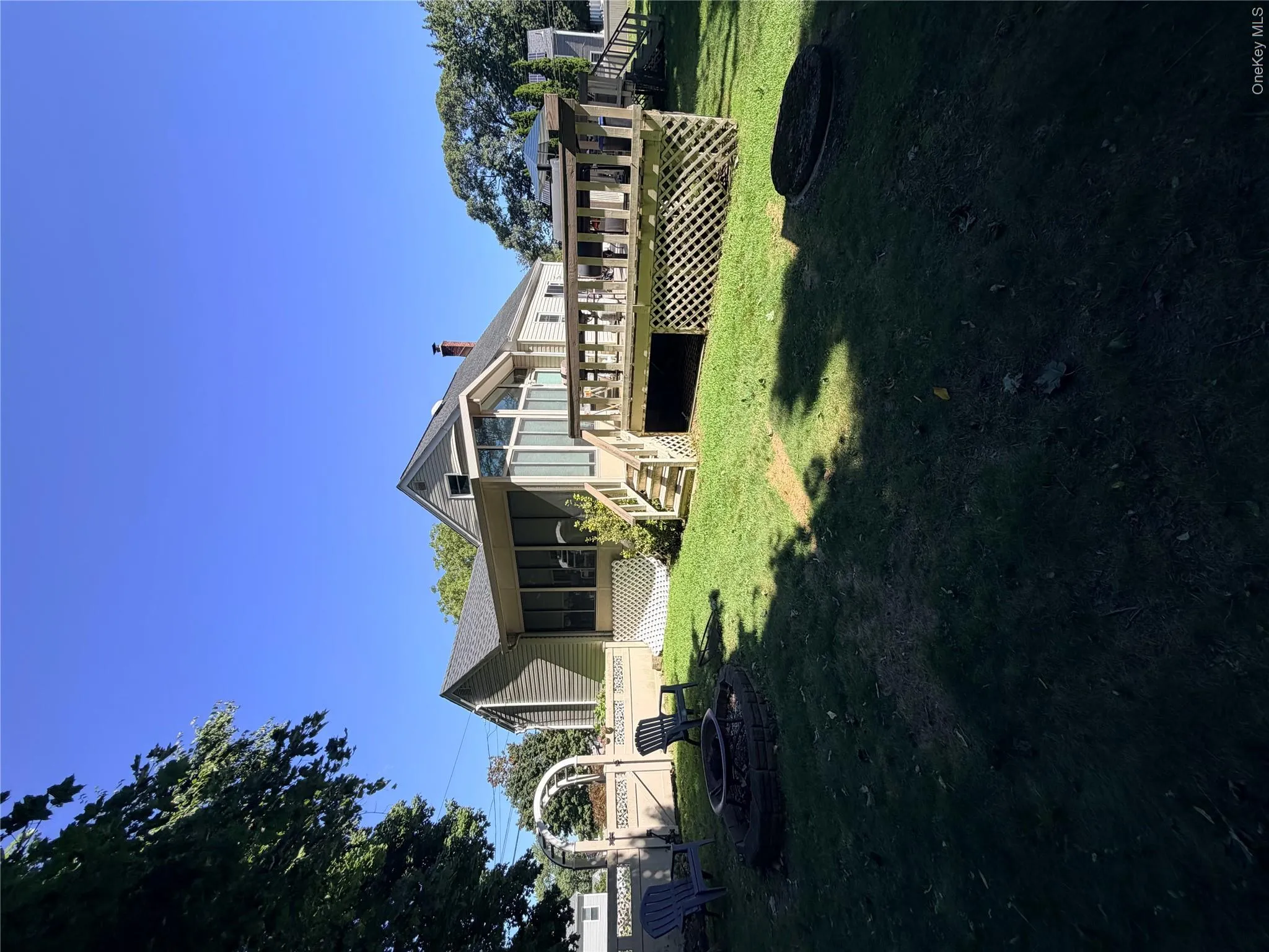 Expansive green lawn featuring a built-in fire pit Expansive green lawn featuring a built-in fire pit