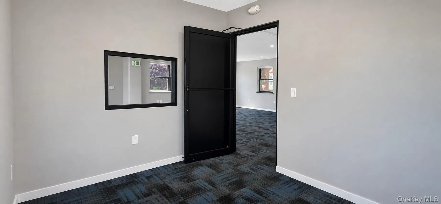 Corner office has interior window and glass door Corner office has interior window and glass door