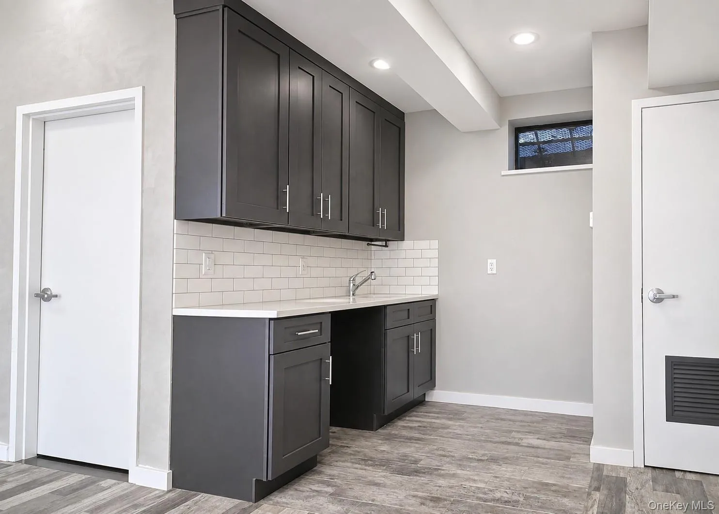 Updated pantry with dark-stained wood cabinets and quartz countertops Updated pantry with dark-stained wood cabinets and quartz countertops