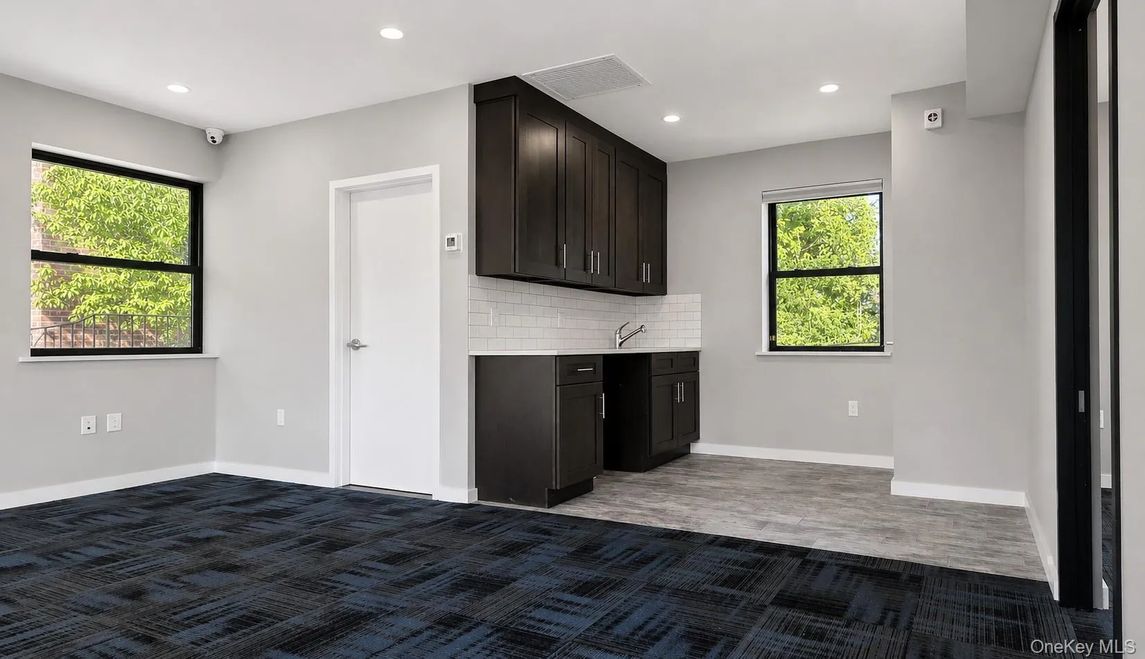 Updated pantry has dark-stained wood cabinets and quartz countertops Updated pantry has dark-stained wood cabinets and quartz countertops