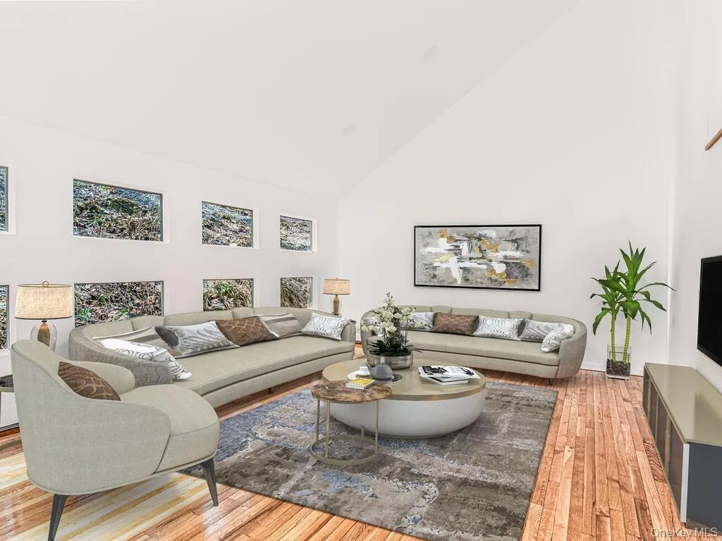 Vaulted ceiling, walls of windows and gleaming hardwood floors. Sliders to rear deck Vaulted ceiling, walls of windows and gleaming hardwood floors. Sliders to rear deck