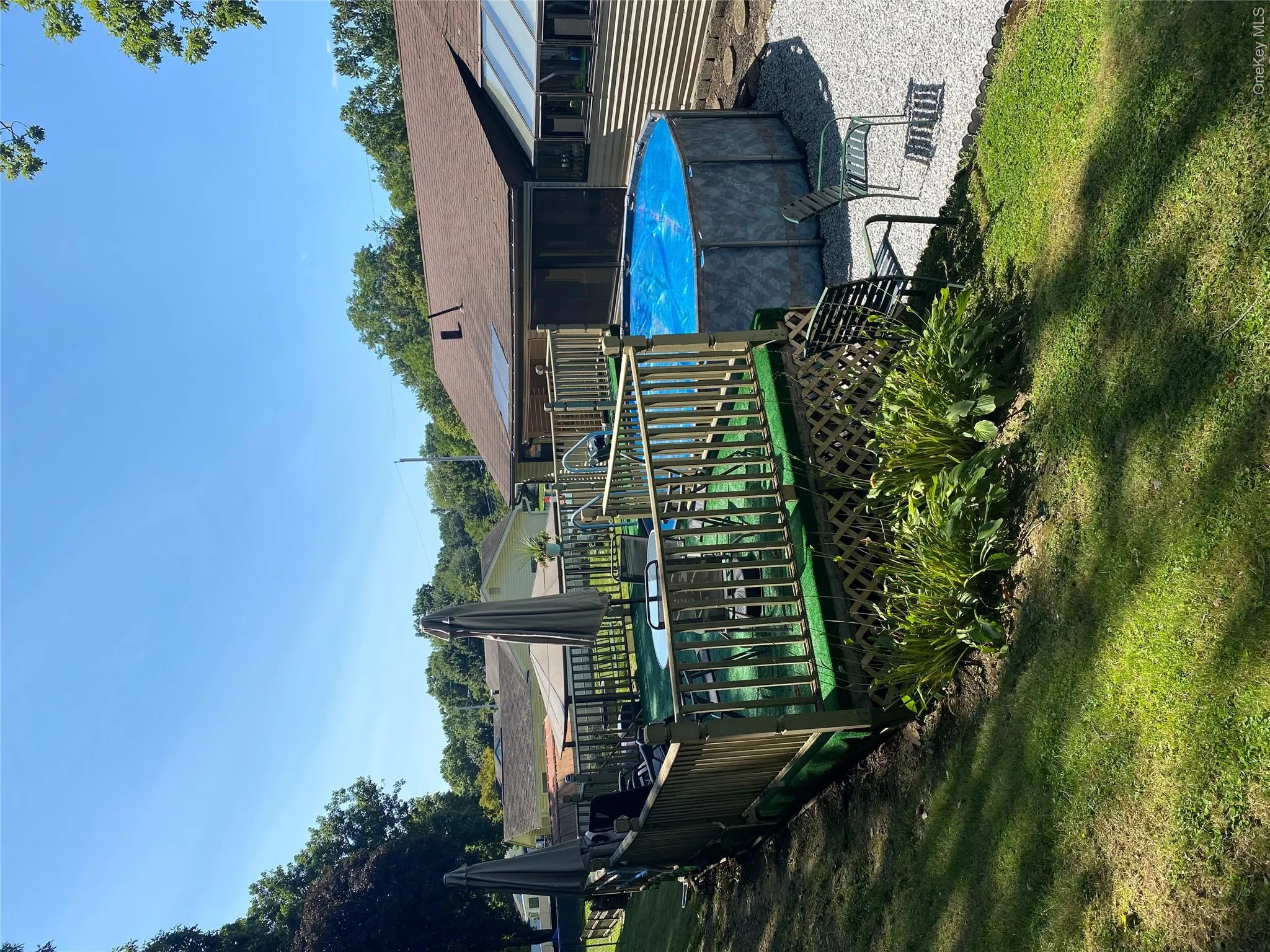 Raised wooden deck with lattice skirting Raised wooden deck with lattice skirting
