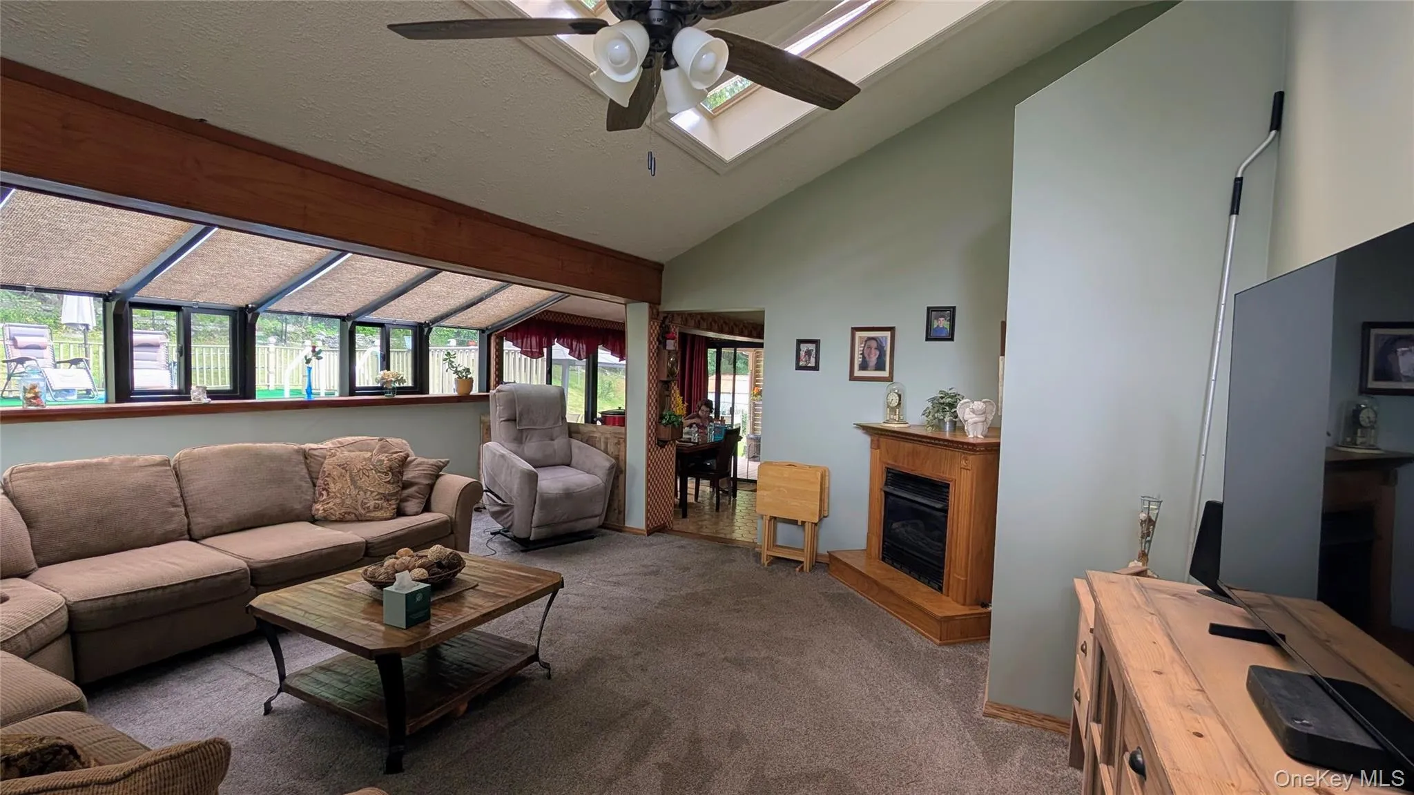 Vaulted ceiling with skylight, ceiling fan, and recessed lighting Vaulted ceiling with skylight, ceiling fan, and recessed lighting