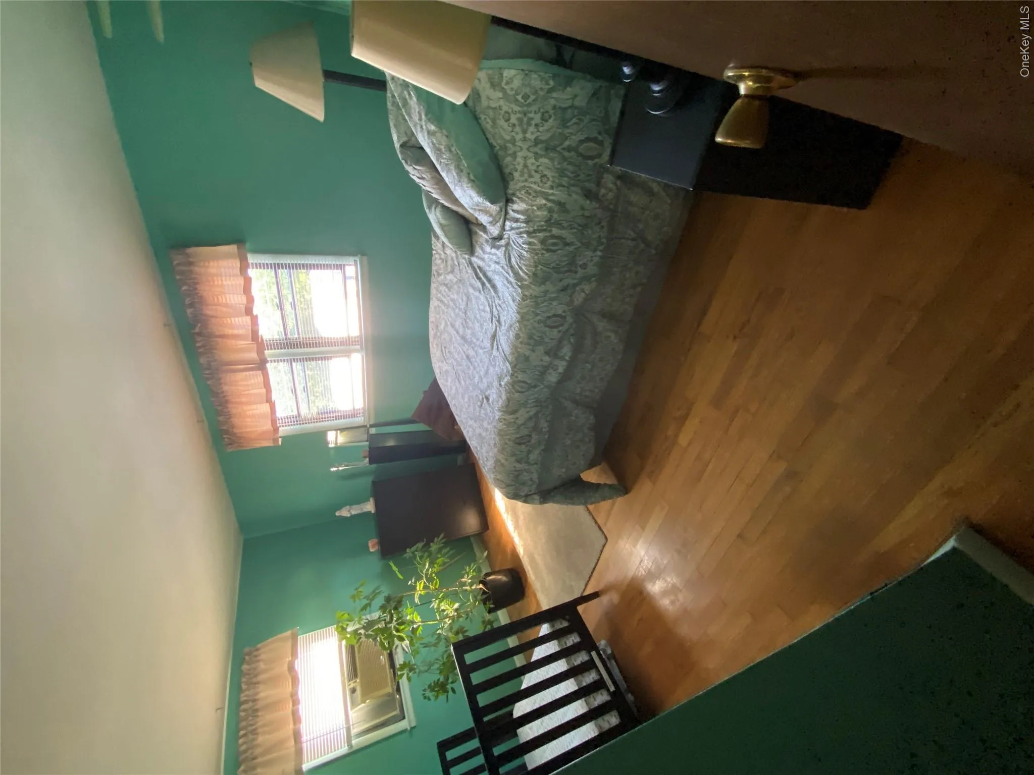 Wood-finish flooring with a vibrant wall color and multiple windows Wood-finish flooring with a vibrant wall color and multiple windows