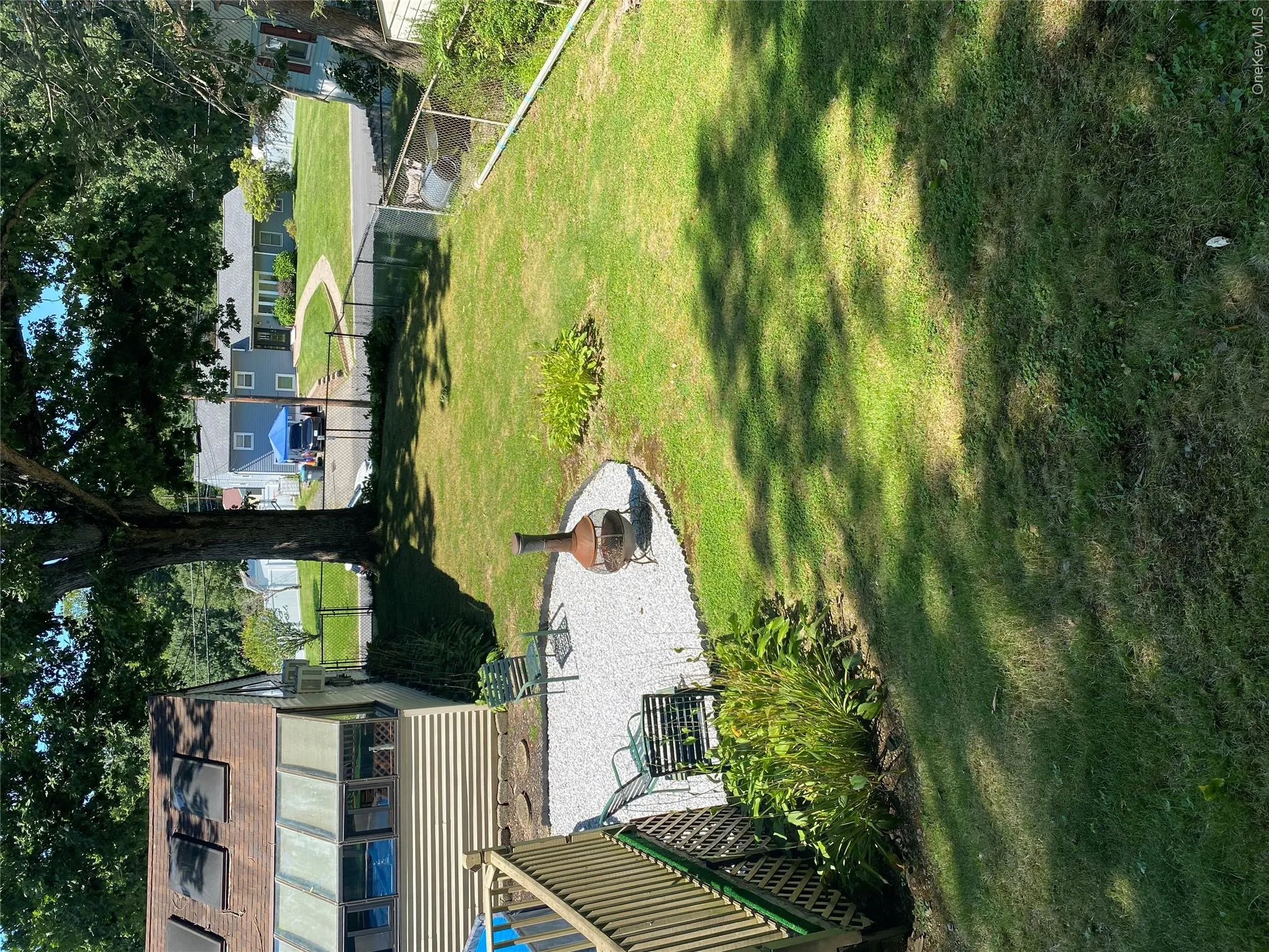 Expansive green lawn with a gravel patio Expansive green lawn with a gravel patio