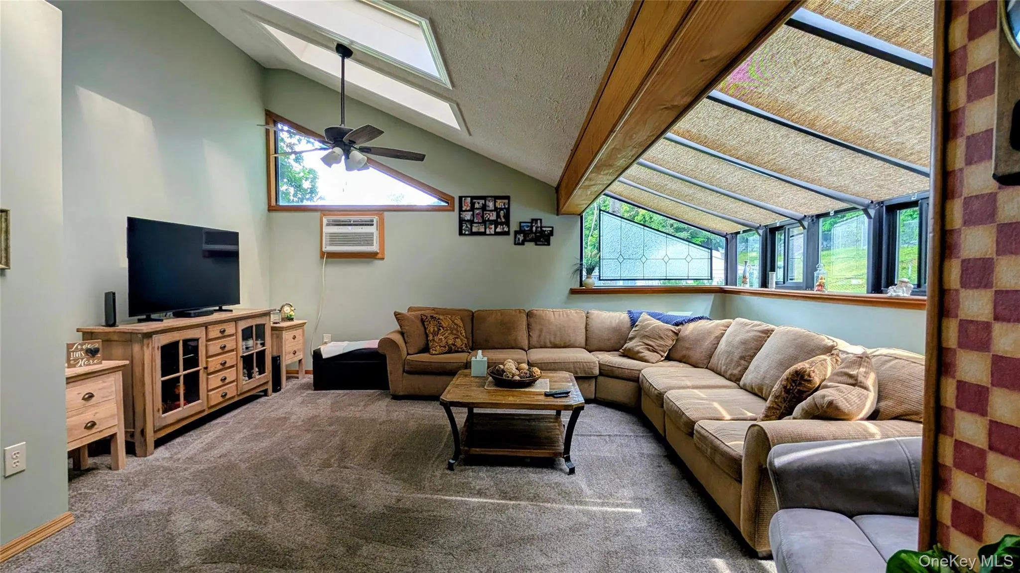 Vaulted ceiling featuring skylights and a ceiling fan Vaulted ceiling featuring skylights and a ceiling fan