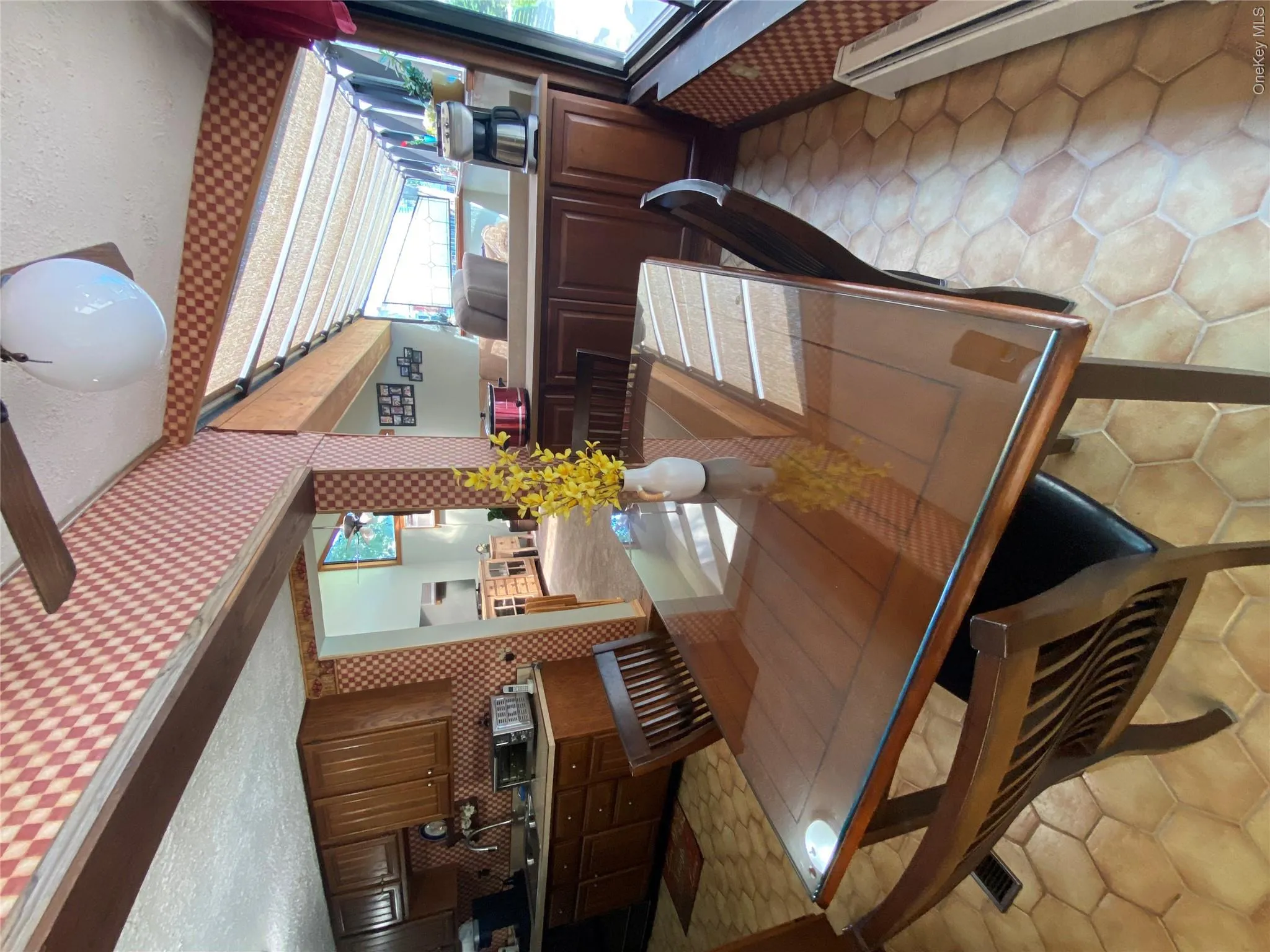Hexagonal floor tiling, wood-finish cabinetry, and a ceiling fan with integrated lighting Hexagonal floor tiling, wood-finish cabinetry, and a ceiling fan with integrated lighting