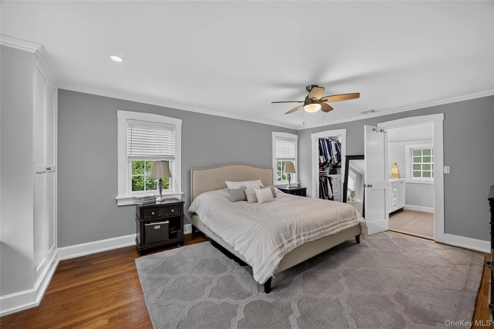 Wood-finish flooring, recessed lighting, ceiling fan, and built-in cabinetry Wood-finish flooring, recessed lighting, ceiling fan, and built-in cabinetry