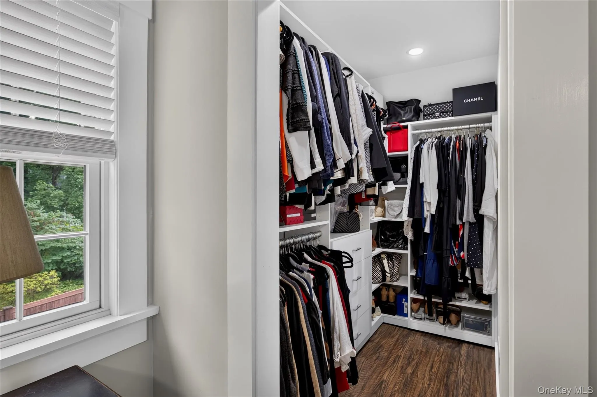 Walk-in closet featuring California Closet System Walk-in closet featuring California Closet System