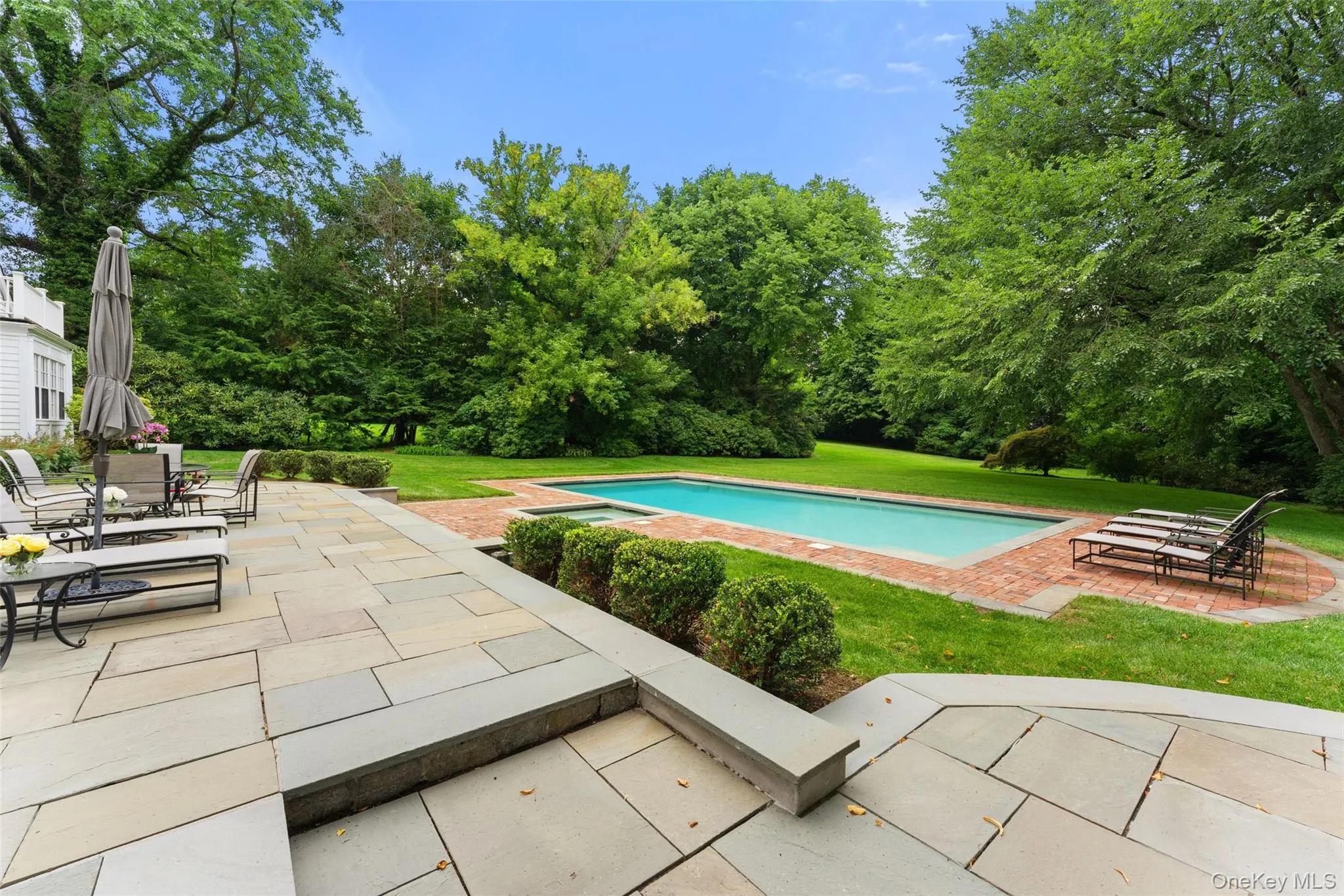 Blue stone patio overlooking pool and grounds Blue stone patio overlooking pool and grounds