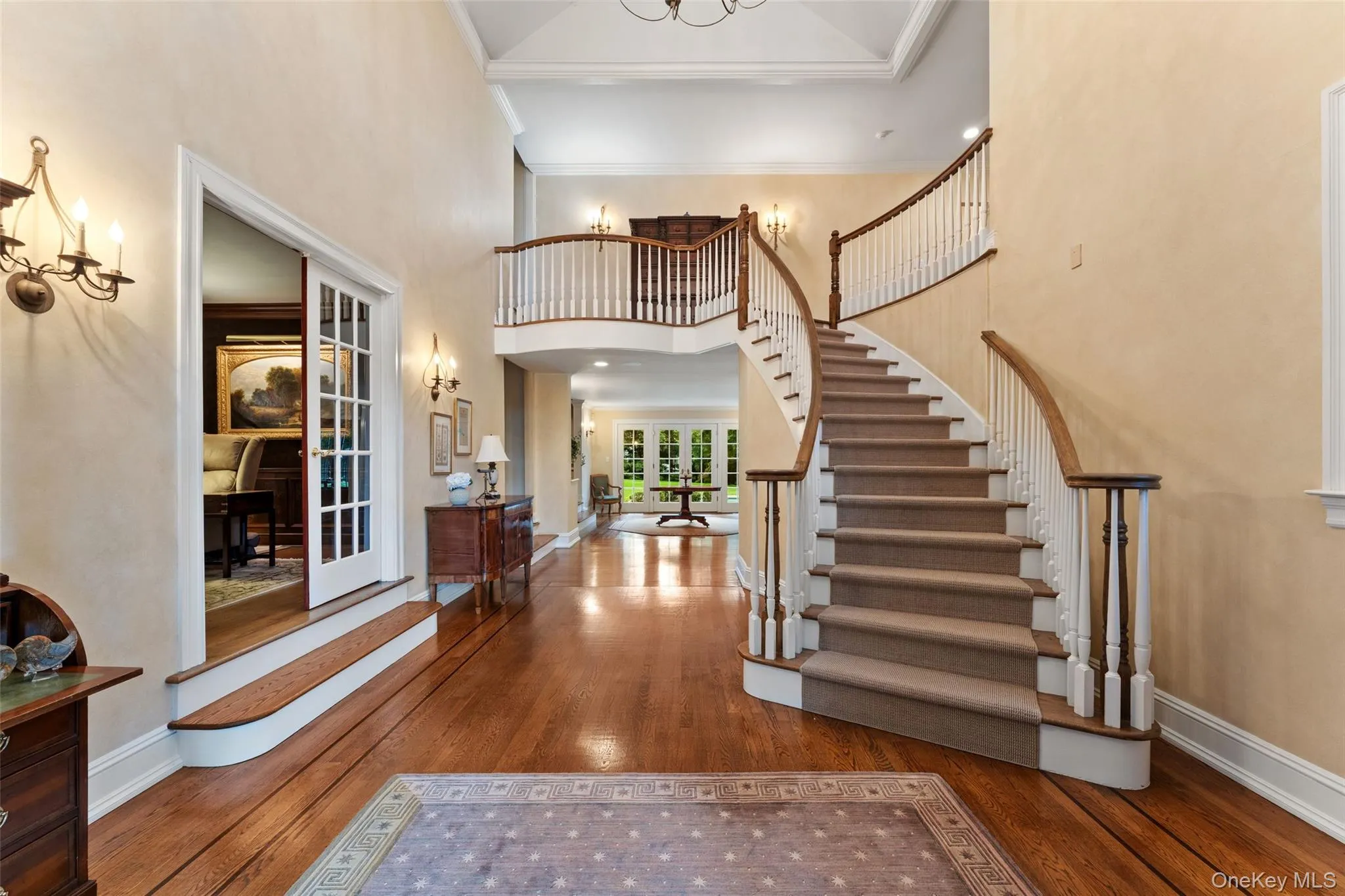 Grand double height entry foyer with curved staircase Grand double height entry foyer with curved staircase