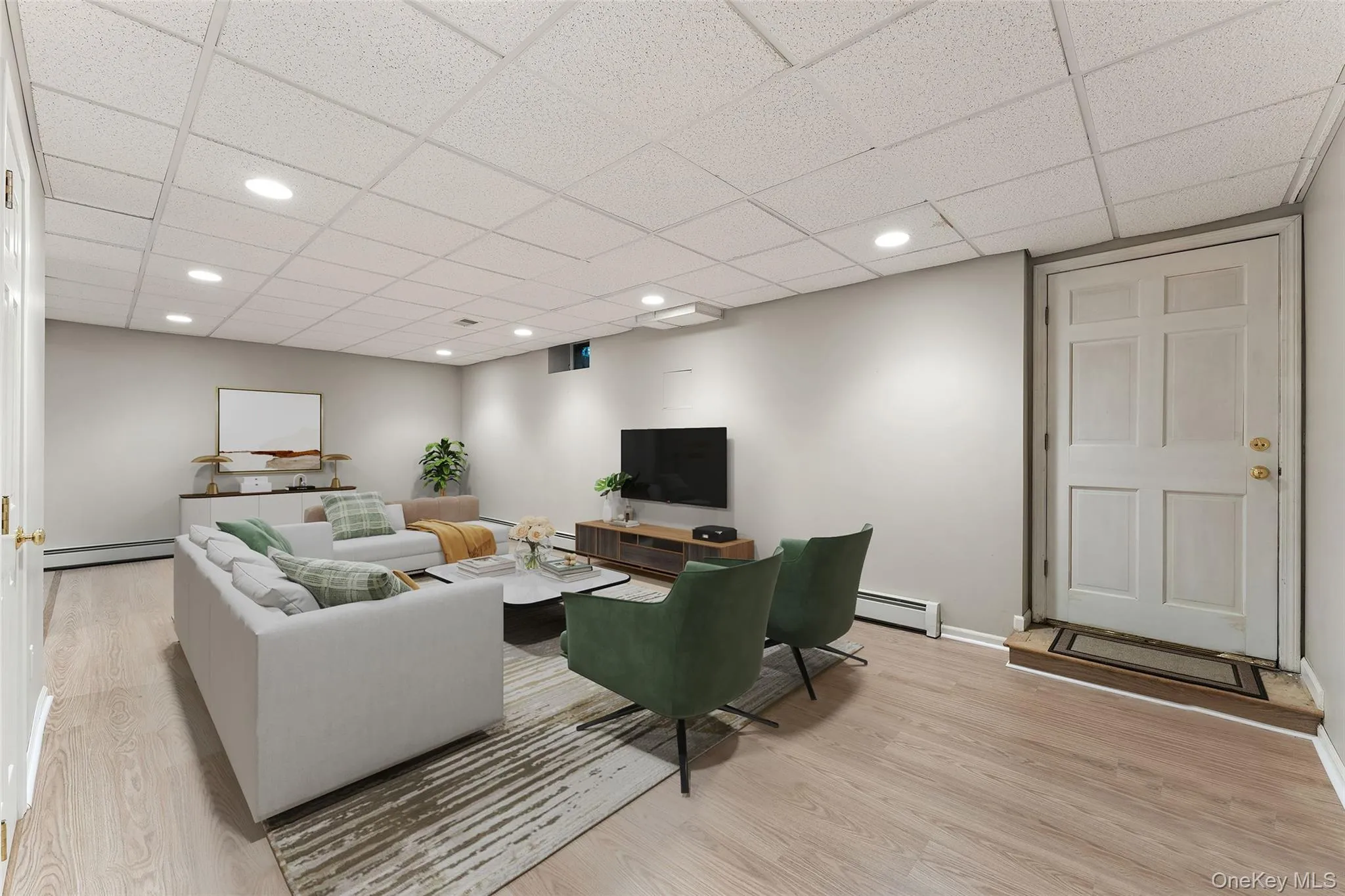View of lower level recreation room virtually staged View of lower level recreation room virtually staged