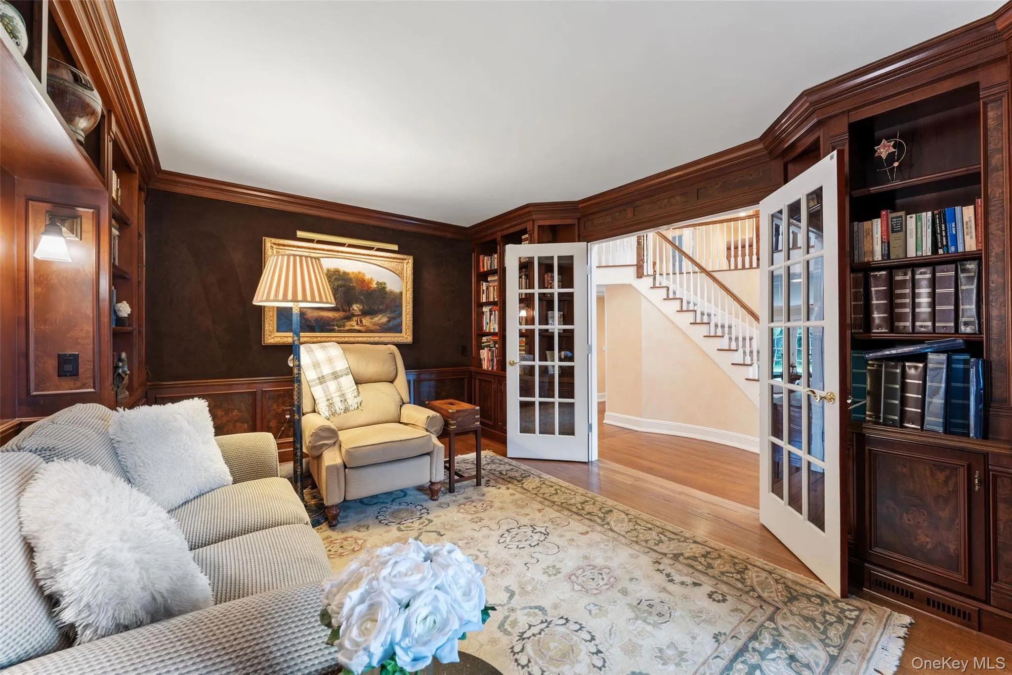 Library with custom built in shelving and french doors Library with custom built in shelving and french doors