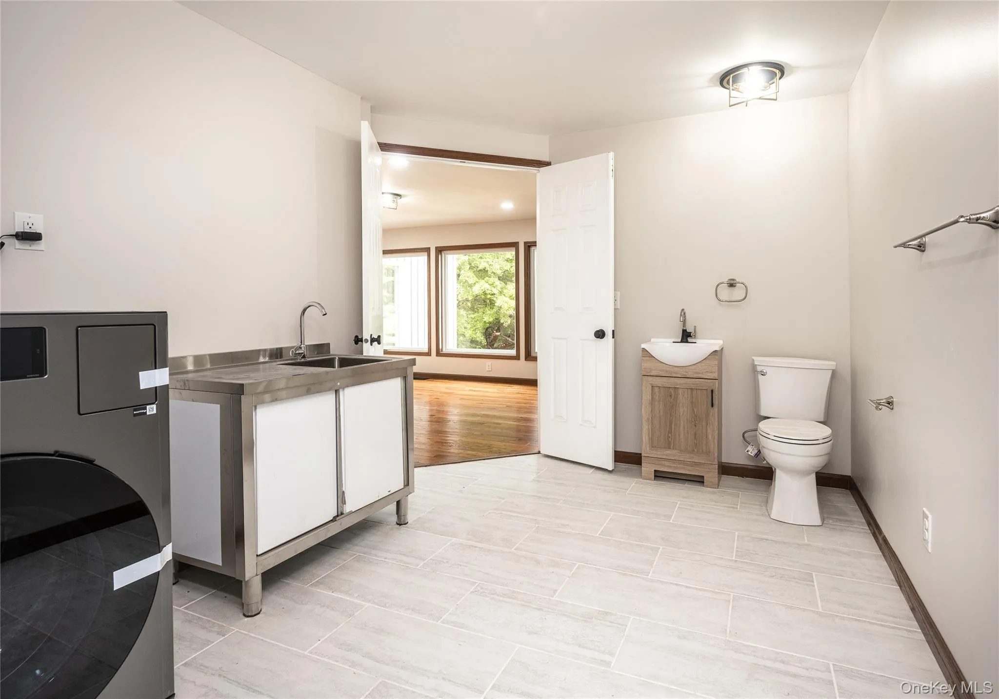 There are two laundry rooms in this home- one on each floor - each featuring a one & done washer ad dryer and a utility sink. This one also features a toilet area. There are two laundry rooms in this home- one on each floor - each featuring a one & done washer ad dryer and a utility sink. This one also features a toilet area.