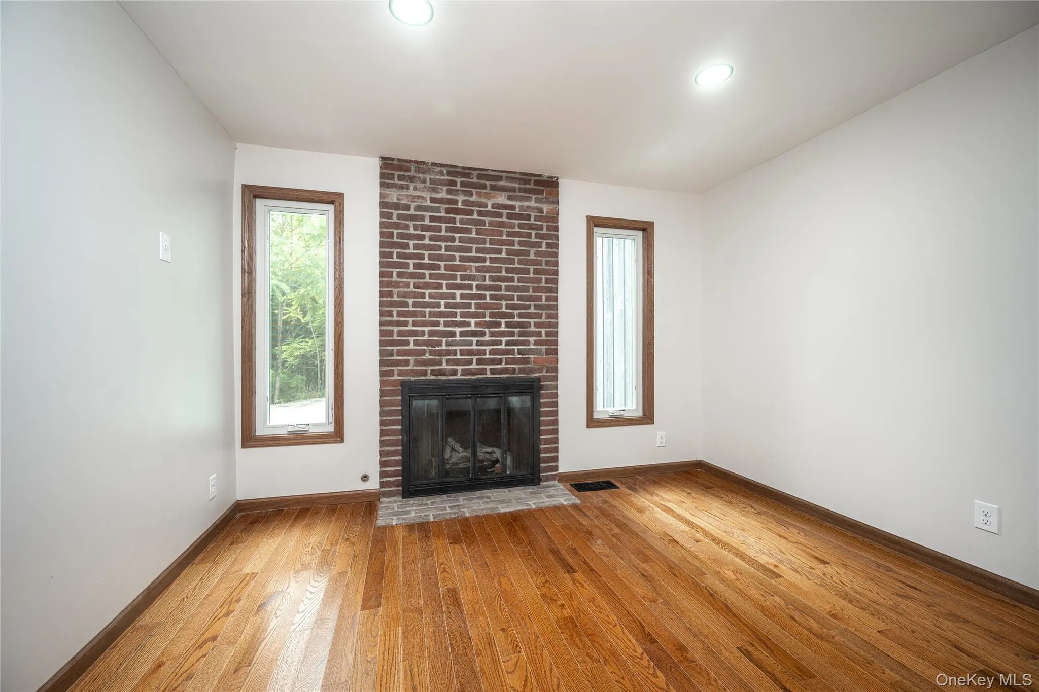 The den is a cozy room with a brick faced fireplace The den is a cozy room with a brick faced fireplace